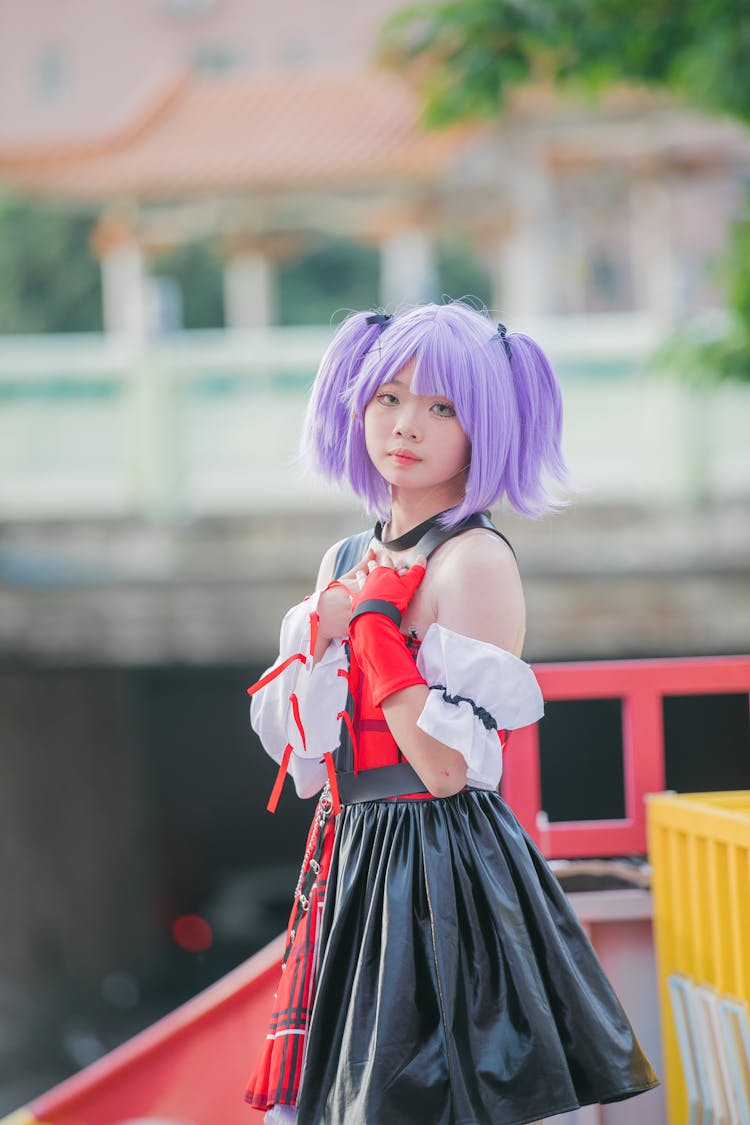 Teenager Girl In Purple Wig And Costume Cosplaying A Video Game Character