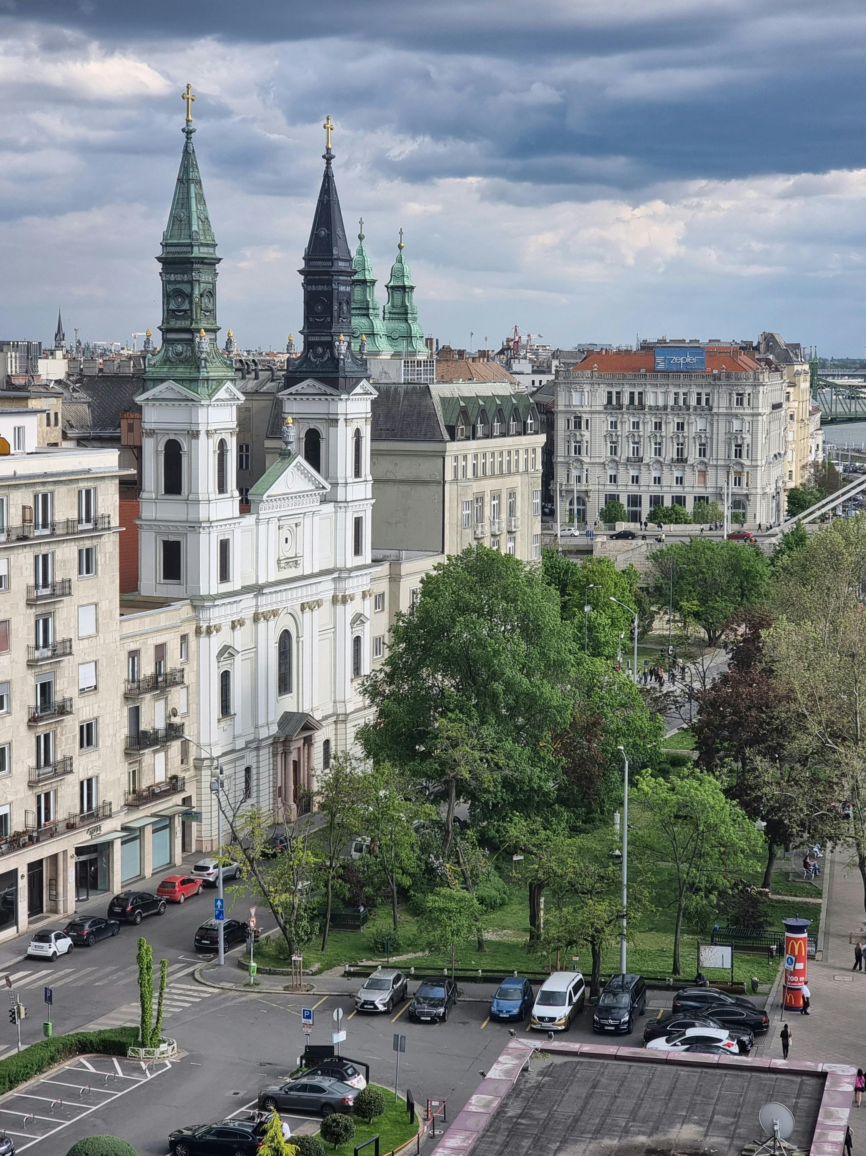 Aerial view of a historic church and surrounding buildings in Budapest, Hungary.