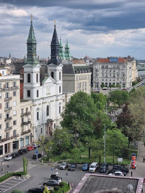 Aerial view of a historic church and surrounding buildings in Budapest, Hungary.