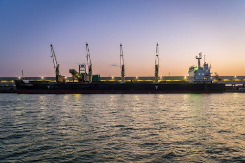 Cargo Ship Docked in Port in Dusk