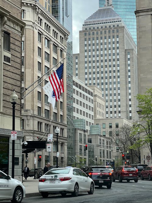 American Flag over Cars on City Street