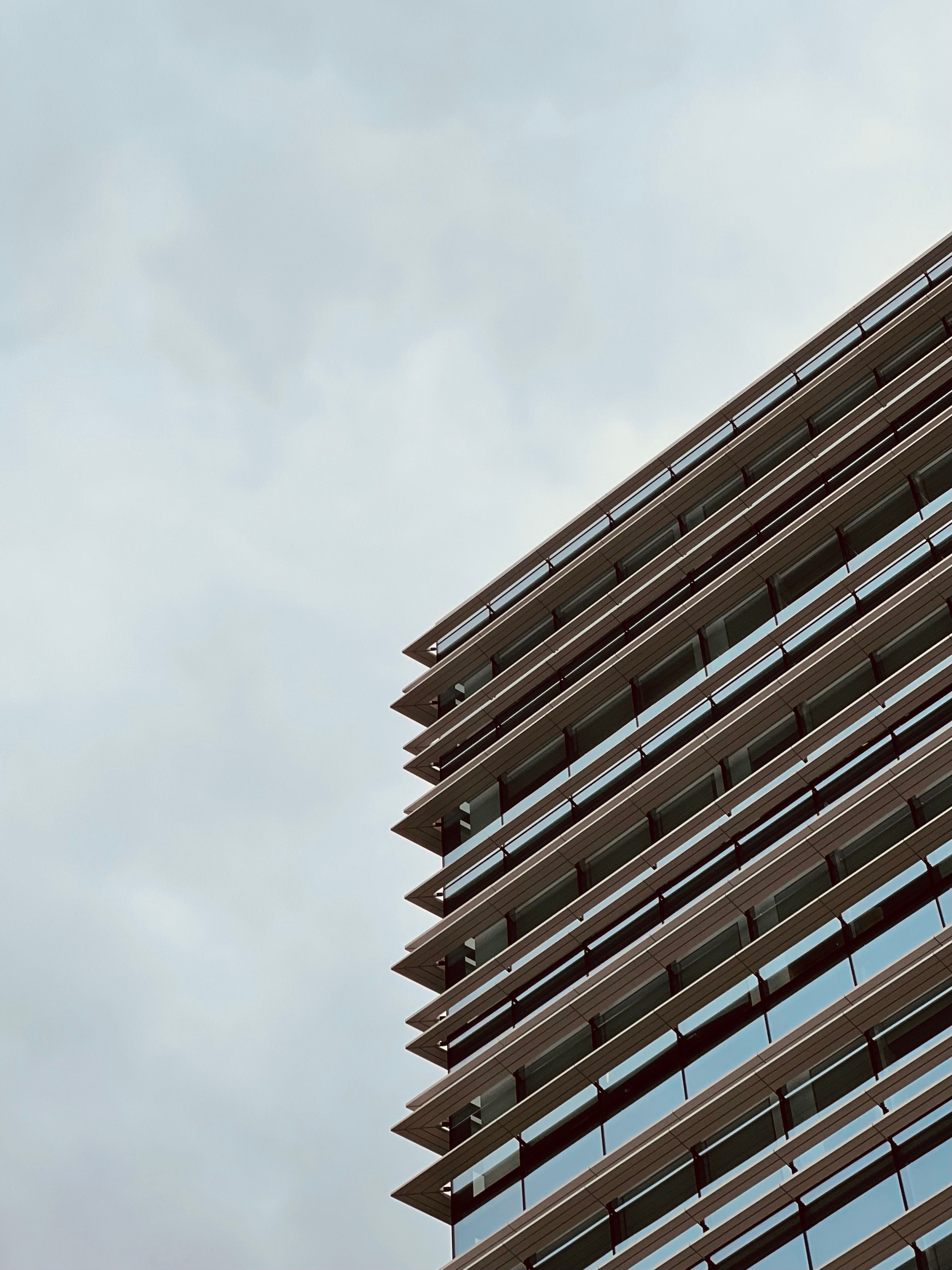 Modern Office Building Against Cloudy Sky · Free Stock Photo