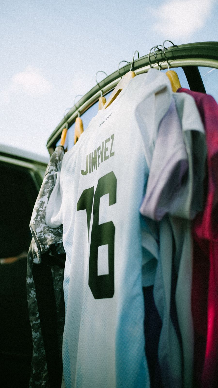 A white football jersey hanging on a clothing rack