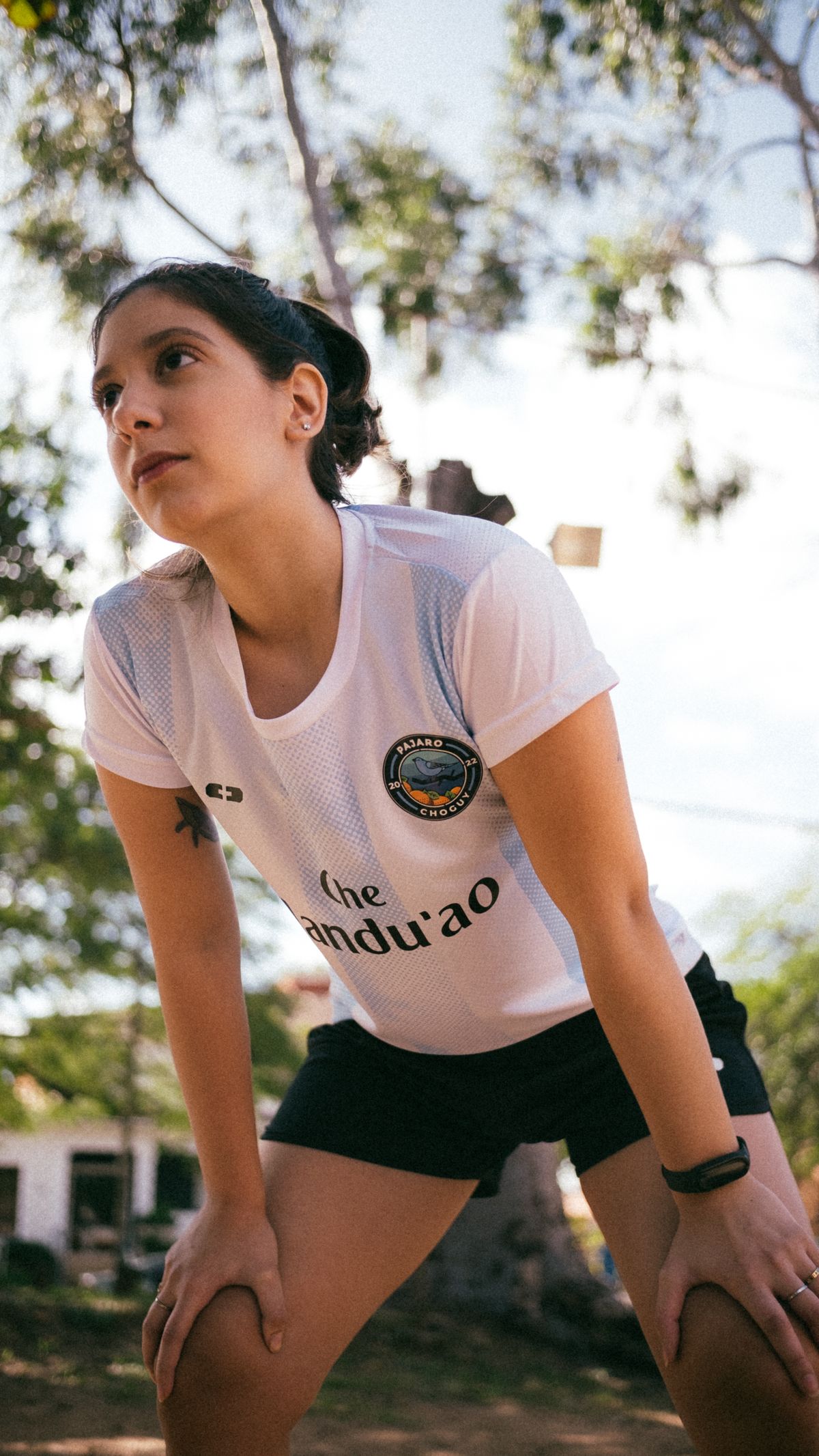 Female runner wearing a performance T-shirt and athletic shorts outdoors