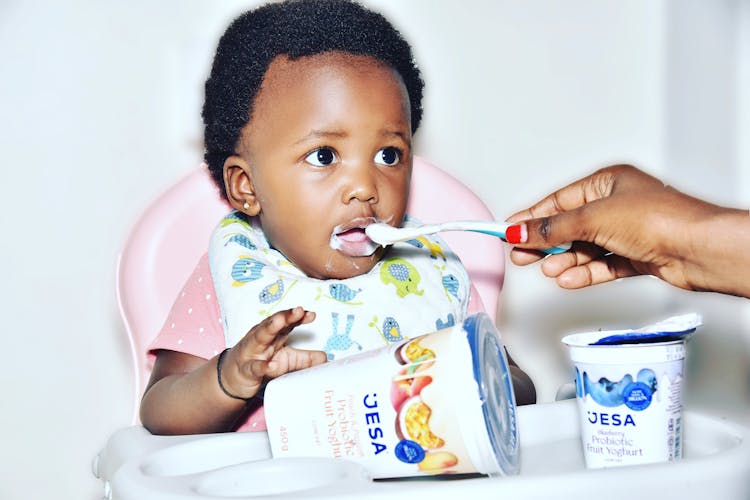 Mother Hand Feeding Son