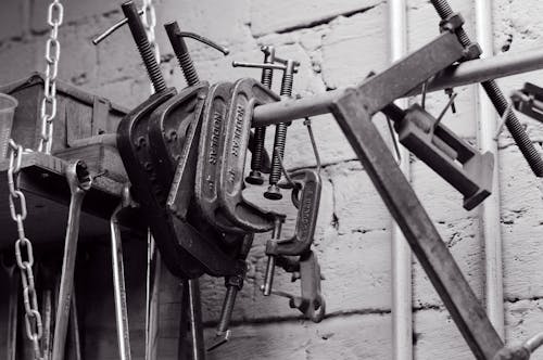 Close-up of Press Tools and Wrenches Hanging in a Workshop 