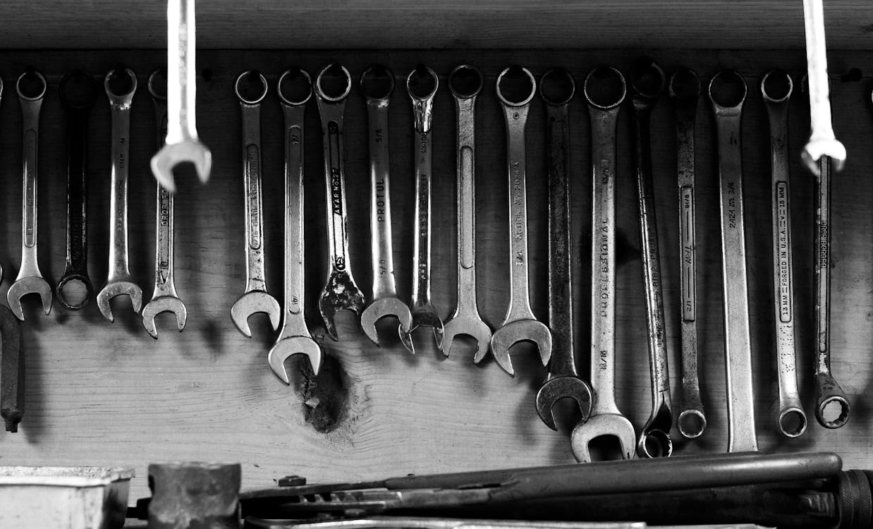 Black and White Photo of a Set of Steel Wrenches Hanging on a Wall