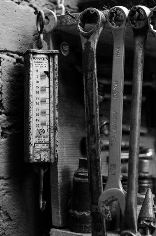 Black and White Photo of Wrenches and a Scale 