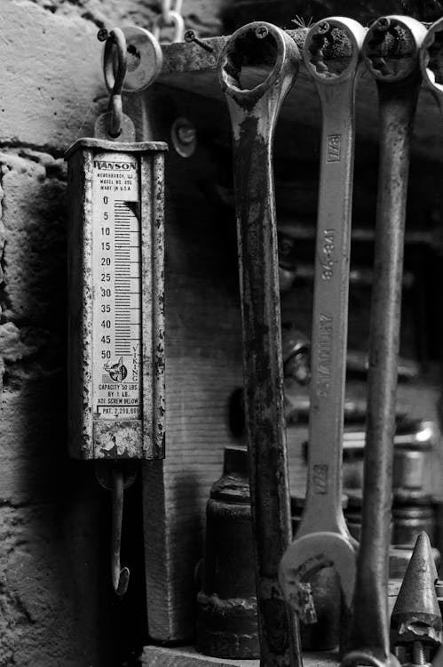 Black and White Photo of Wrenches and a Scale 