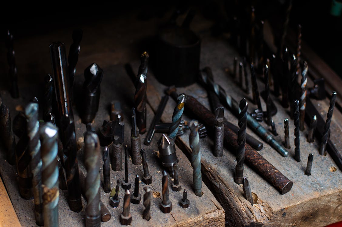 Close-up of a Set of Drill Bits Stuck in a Wooden Board 