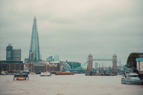 Free Captivating view of Tower Bridge and the Shard from the Thames, showcasing London's skyline. Stock Photo