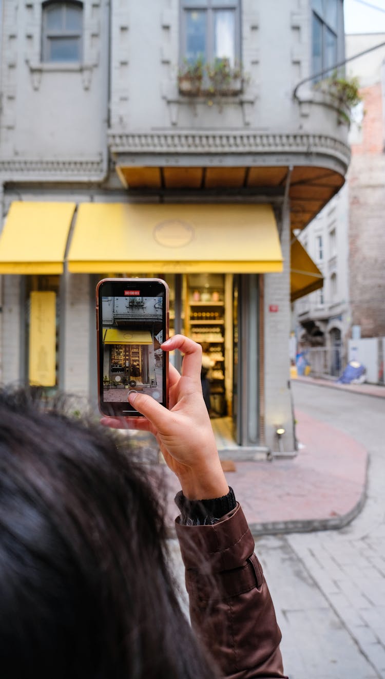 Woman Taking Pictures Of Building