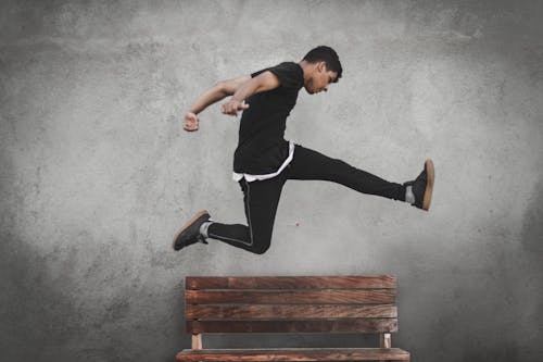 Man Jumping over Bench