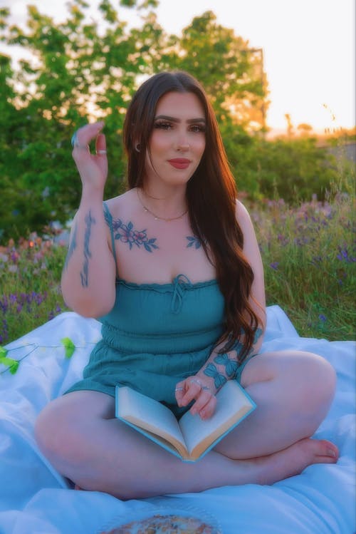 Woman Sitting with Book on Picnic