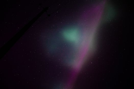 Capture the ethereal beauty of the aurora borealis illuminating the night sky in vivid colors.