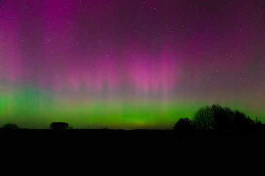 Beautiful aurora borealis lights up the night sky with vibrant colors and stars.