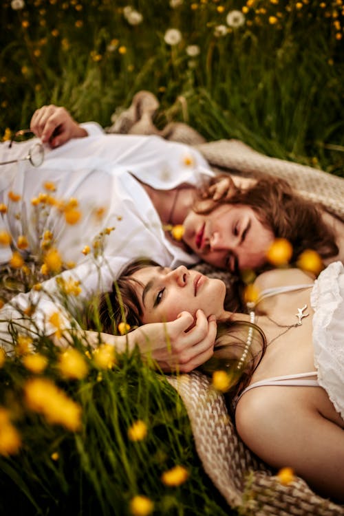 Free Couple Lying Down on Meadow Stock Photo