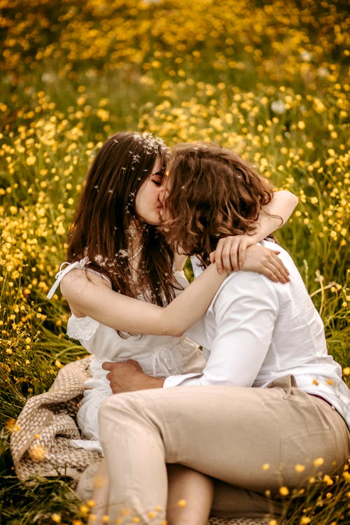 Couple Hugging and Kissing among Flowers