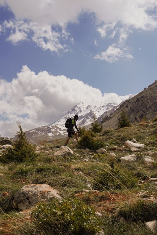 Free A hiker ascends a scenic mountain trail in sunny Antalya, Turkey, showcasing natural beauty. Stock Photo