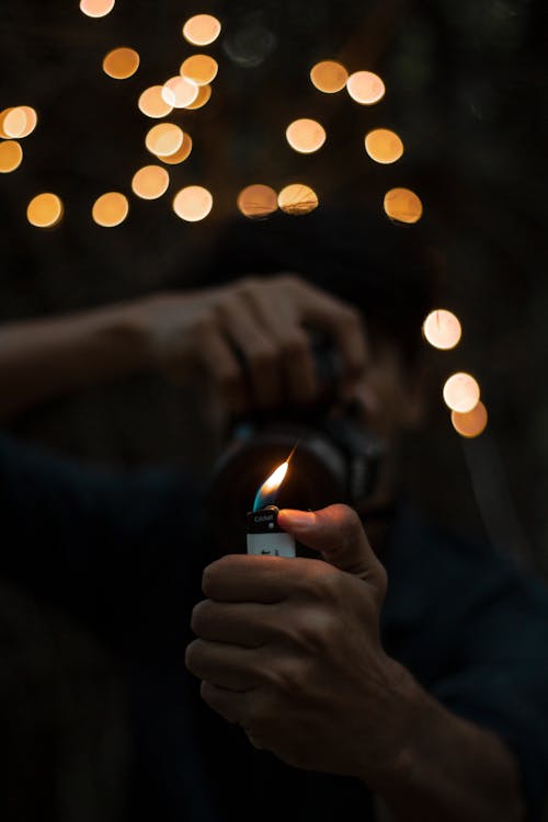 Person Holding Lighted Disposable Lighter