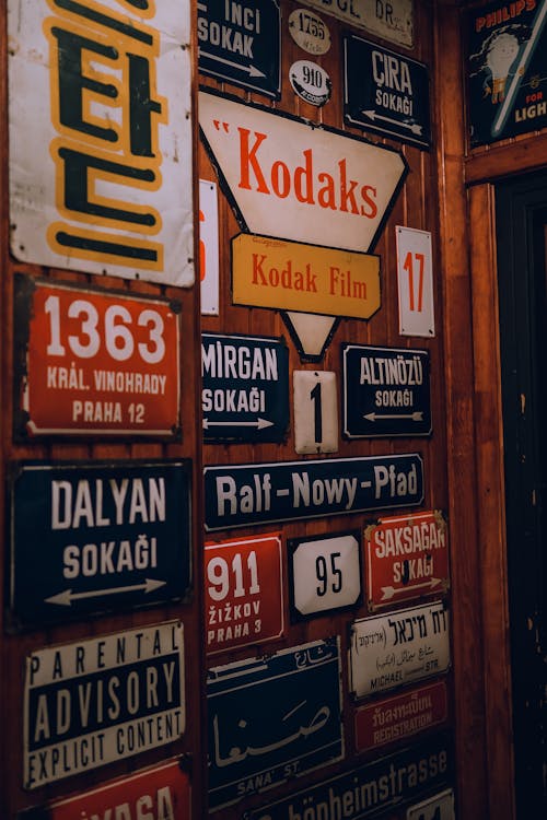 Various Street Name Signs Hanging on a Wall