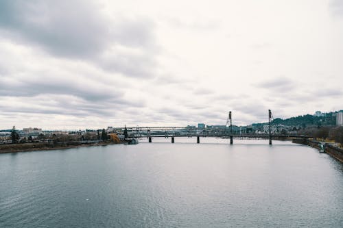 Cloudy Sky over a City Bridge Stretching over a River