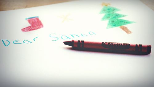Free A festive child's drawing featuring Christmas symbols and a Crayola crayon. Stock Photo