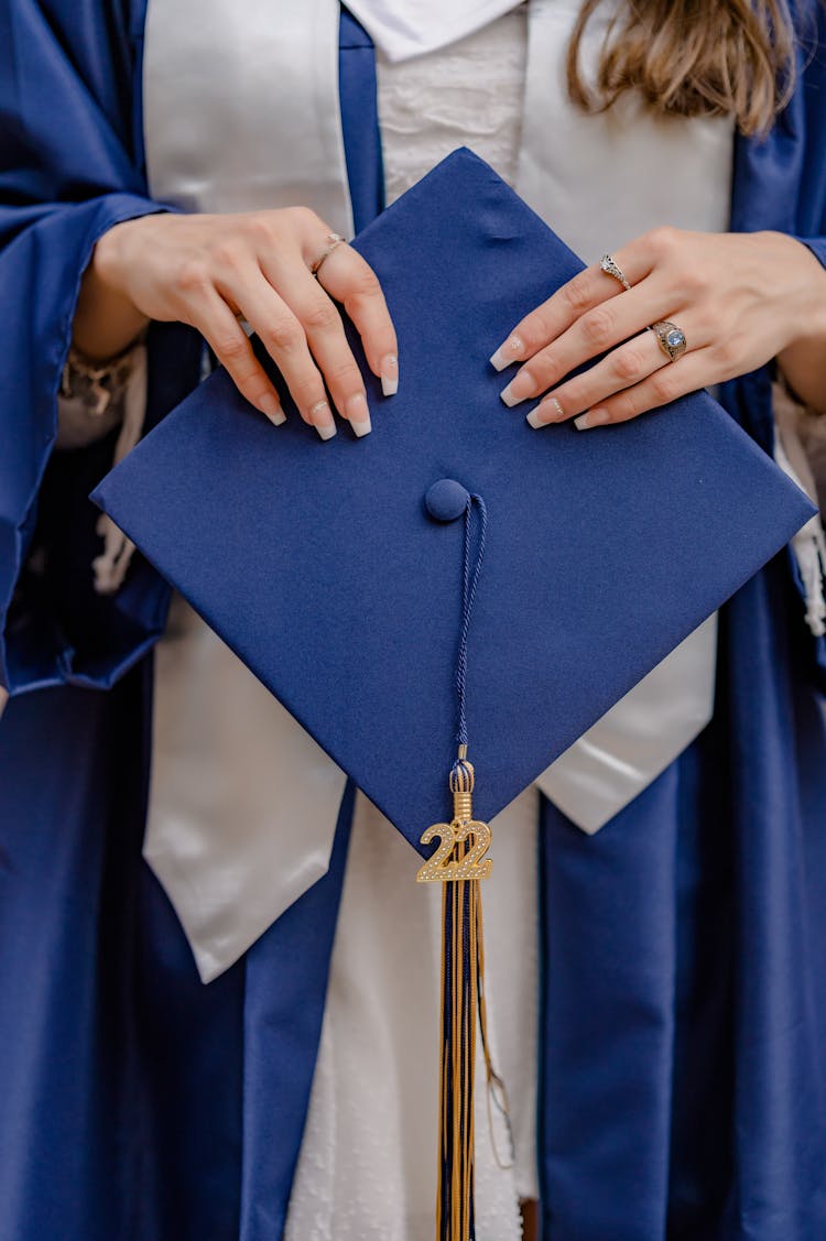 Woman Holding Mortarboard