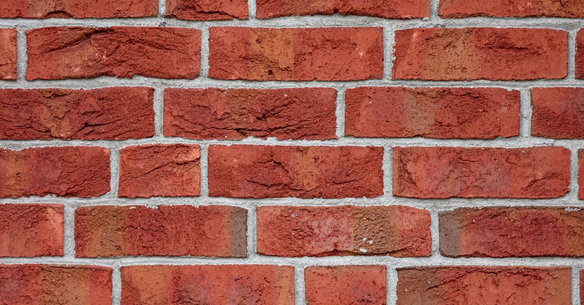 Detailed image of a red brick wall, showcasing texture and urban design pattern.