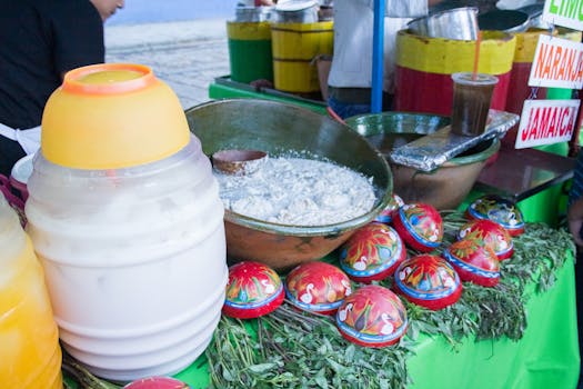Colorful display of traditional food and drinks at a vibrant street food stand in Oaxaca, Mexico.
