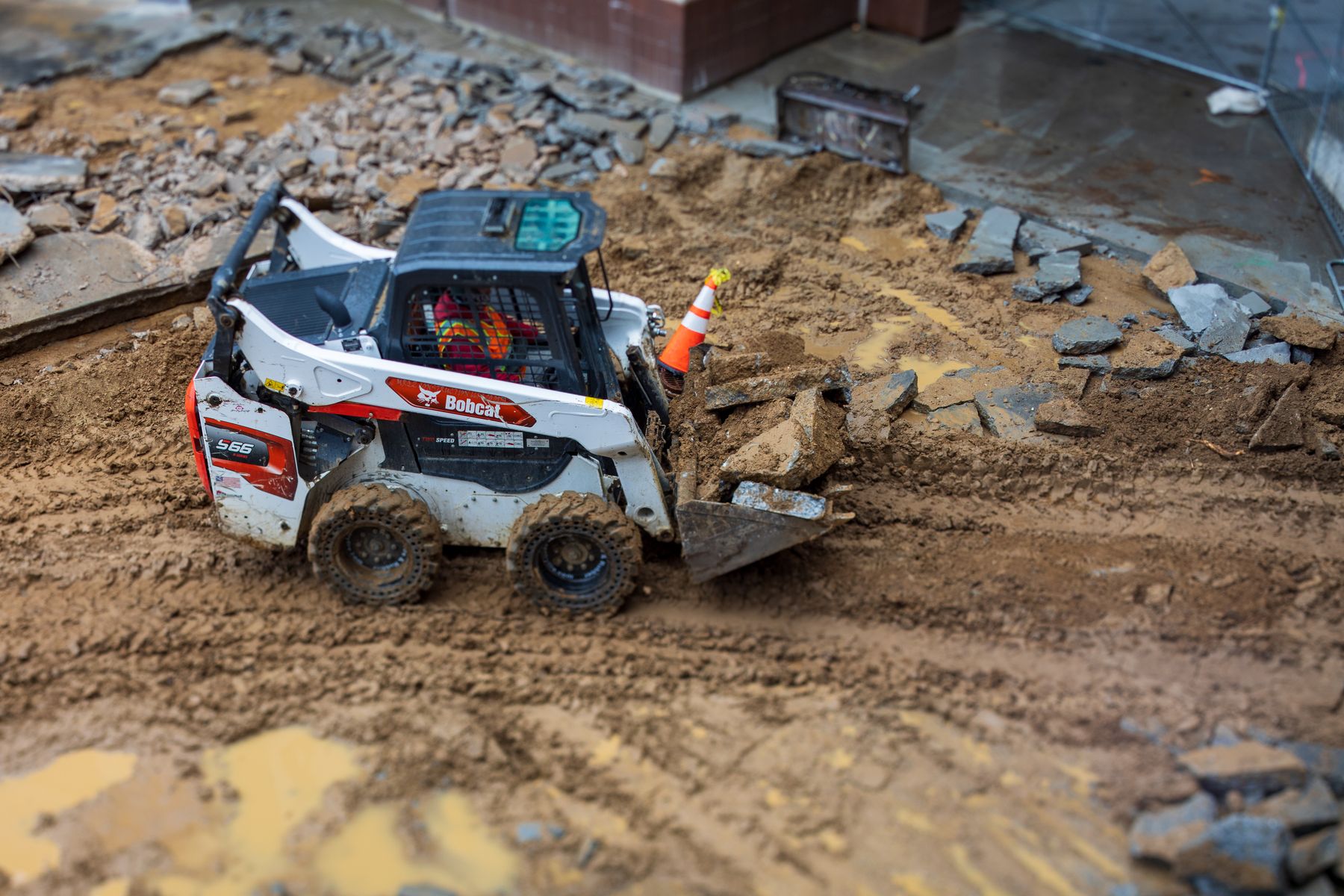 Skid steer preparing construction ground