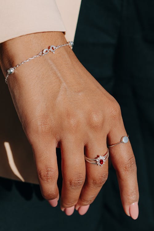 Close-up of Hand of a Woman Wearing a Bracelet and Rings 