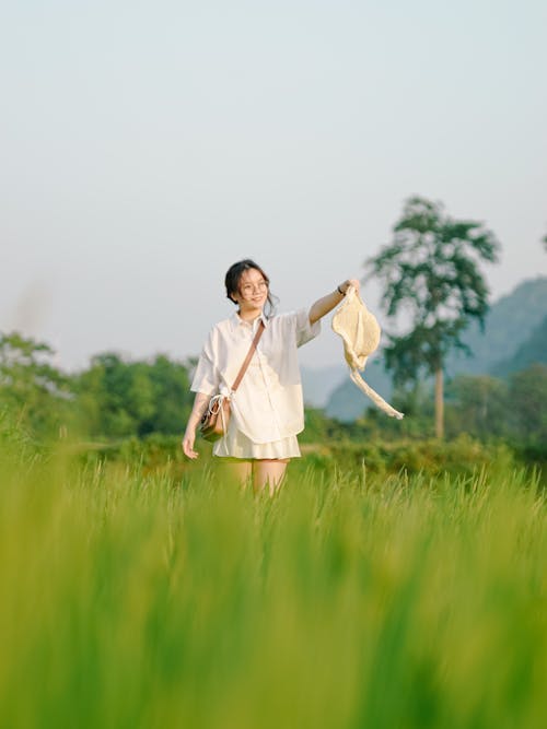 Young Woman on a Grass Field in Summer 