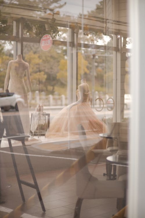 Mannequins inside Fashion Studio seen through Window