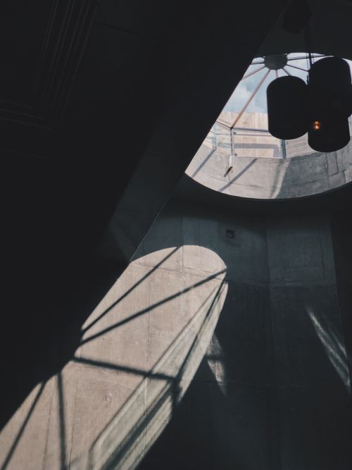 Free Dark shadows cast through a skylight in a modern architectural setting, creating a moody atmosphere. Stock Photo