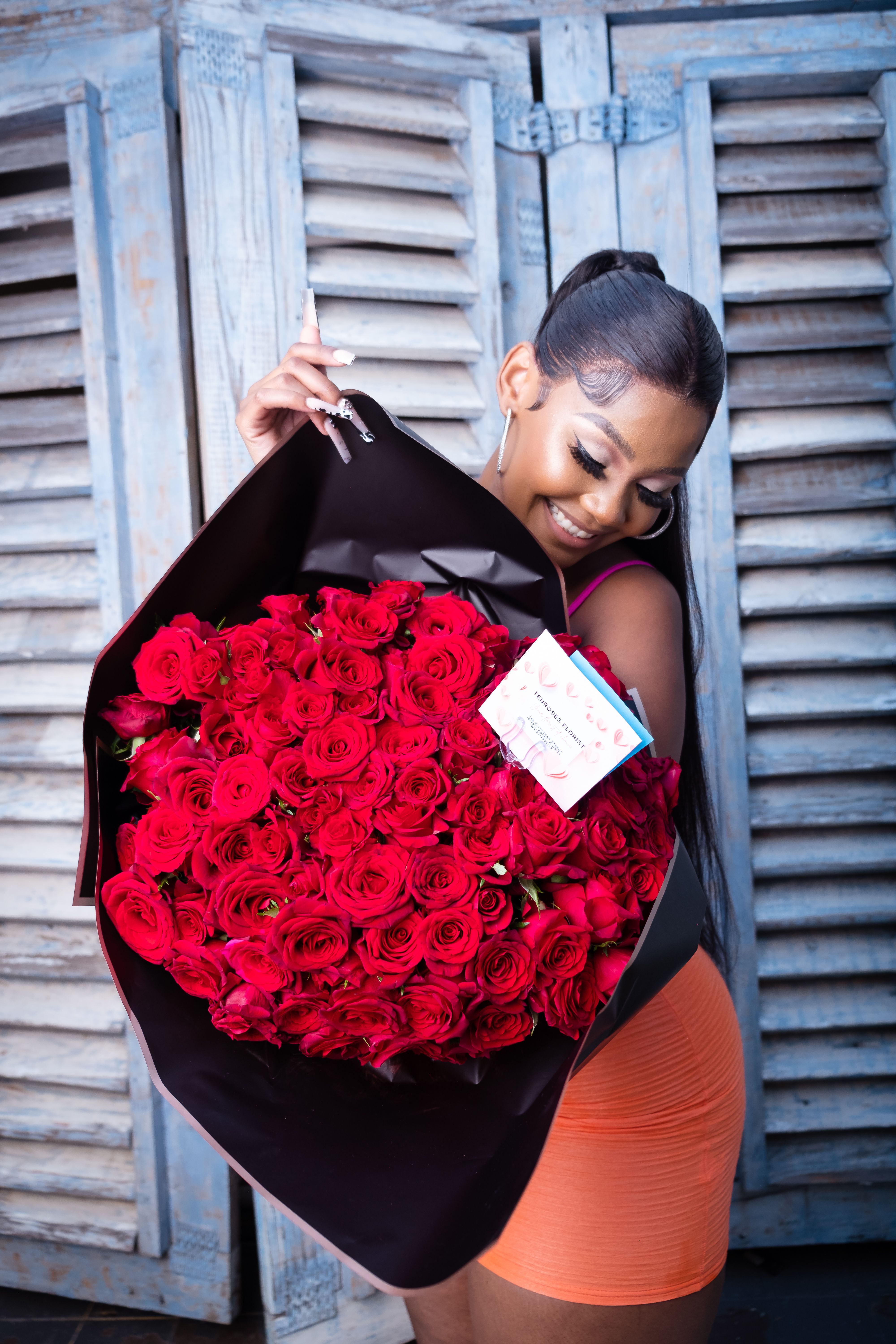 Young Woman Holding a Big Bouquet of Red Roses · Free Stock Photo