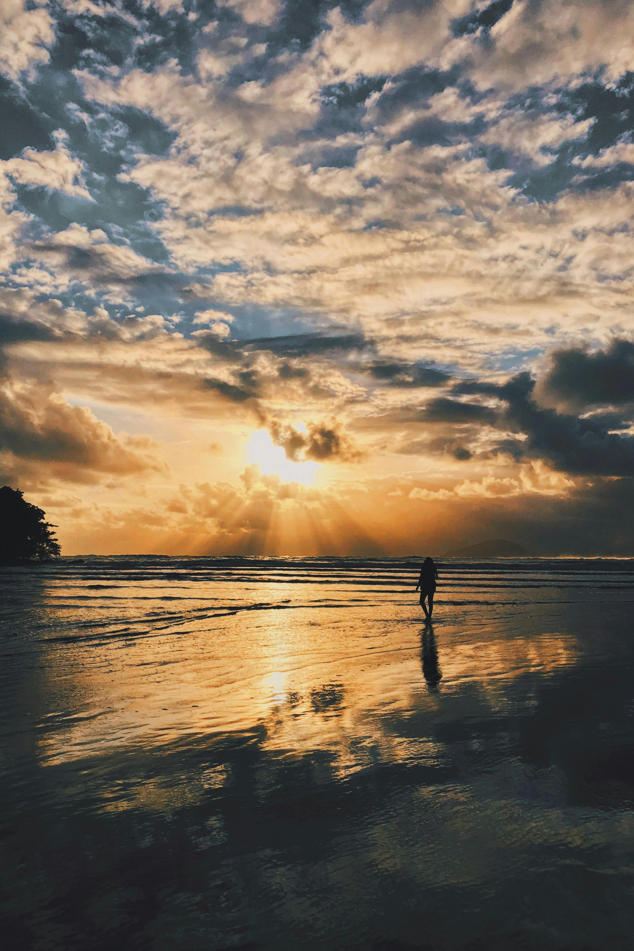 silhouette walking on a stunning sunset beach