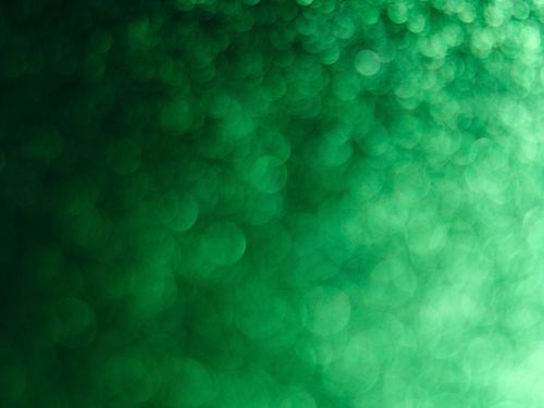 Free Abstract green bokeh background with vibrant circular light patterns. Stock Photo