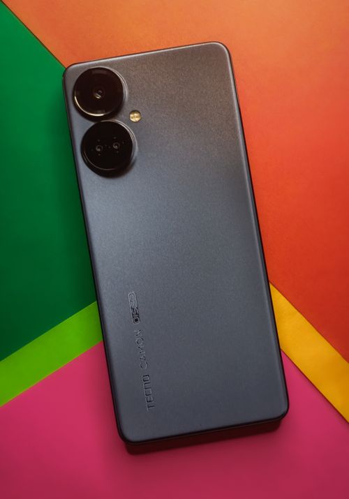 Free Sleek black smartphone showcased against a vibrant, colorful background, highlighting its design. Stock Photo