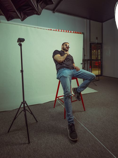 Free Stylish man posing in a Baghdad photo studio, wearing jeans and sunglasses. Stock Photo