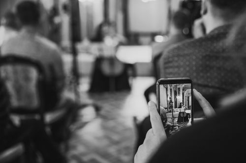 Free Black and white photo of a classical music performance in Hanover, Germany, as seen through a smartphone. Stock Photo