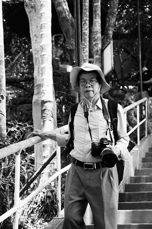 Elderly Man with a Camera Walking on Steps 