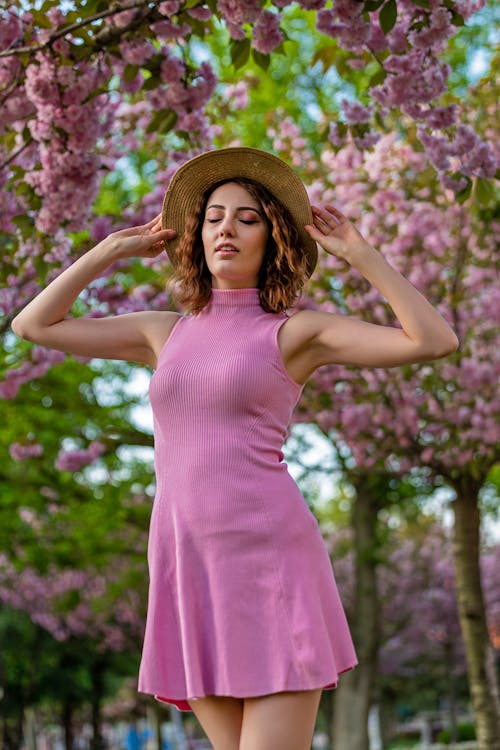 Woman in Pink Dress and Hat