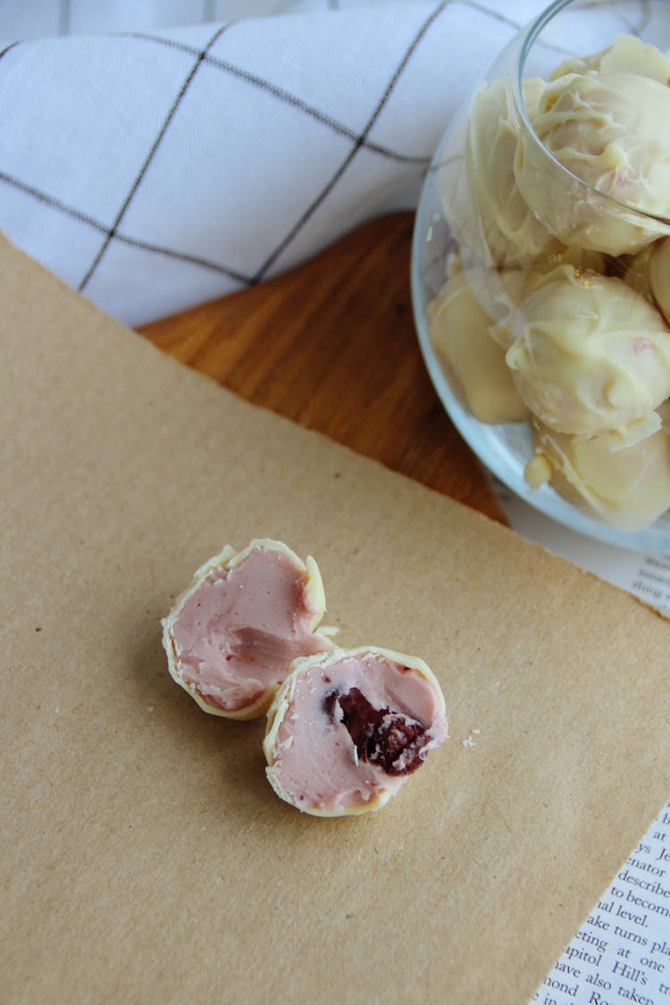 White Chocolate Truffles With Pink Filling On A Table