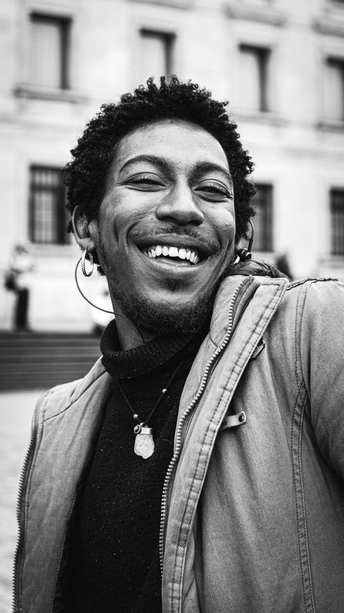 Free Captivating black and white portrait of a smiling man in Bogotá, Colombia. Stock Photo