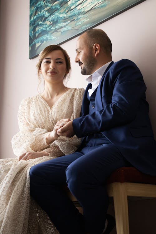 Woman in Dress and Man in Suit Posing Together