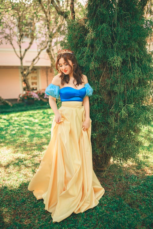 Woman in Princess Costume Posing by Tree