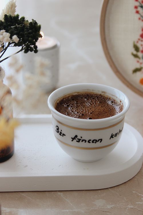 Free A warm cup of Turkish coffee on a tray with decorative items, creating a cozy atmosphere. Stock Photo