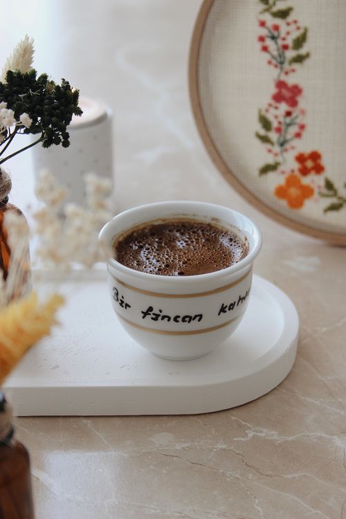 Free Close-up of a coffee cup with intricate embroidery in soft lighting. Stock Photo