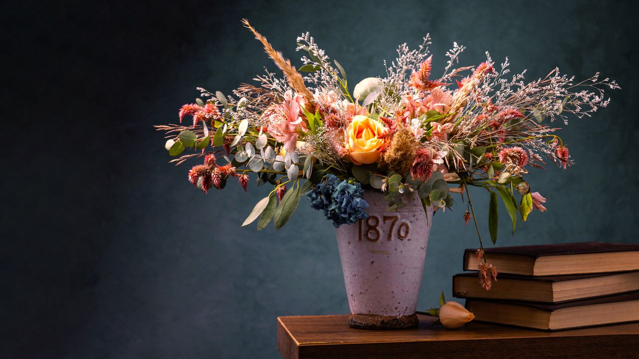 artistic still life featuring a colorful flower arrangement in a vase
